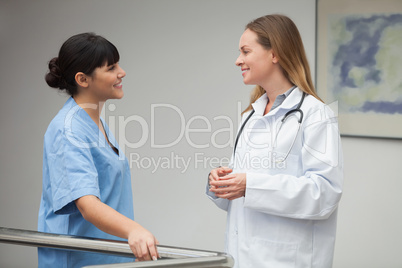 Nurse talking and smiling with female doctor