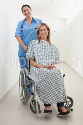 Happy nurse and patient in wheelchair