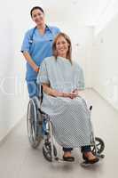 Happy nurse and patient in wheelchair
