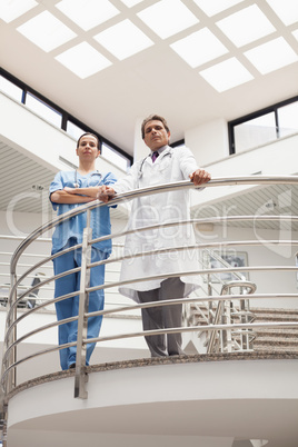 Nurse and doctor standing earnestly at the stairwell
