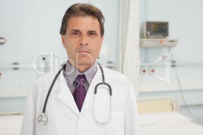 Doctor standing in hospital bedroom