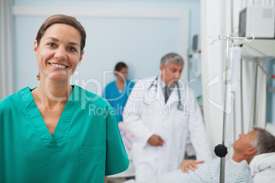 Smiling nurse standing in a hospital room