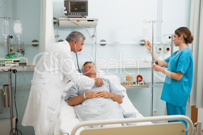 Doctor checking heartbeat of patient with stethoscope