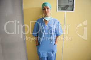 Nurse in scrubs standing in hospital room