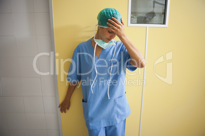 Nurse in scrubs looking worried