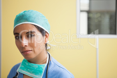 Woman wearing scrubs in hospital room