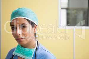 Woman wearing scrubs in hospital room
