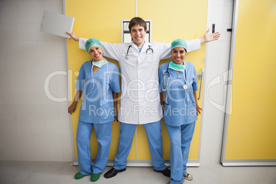 Happy doctor  between two smiling nurses
