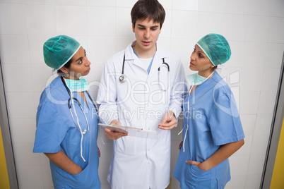 Doctor talking to two nurses