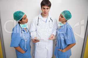 Doctor talking to two nurses