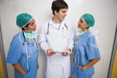 Doctor talks to smiling nurses