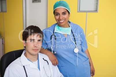 Happy doctor and nurse in yellow office