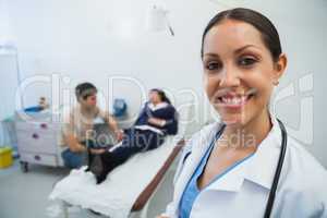 Doctor smiling in hospital room with patient