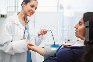 Patients blood pressure being checked by doctor