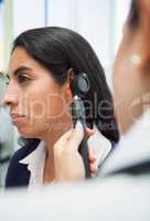 Doctor checking womans ear