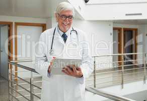 Doctor smiling as looks at patient file