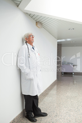 Doctor leaning against wall