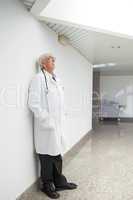 Doctor leaning against wall