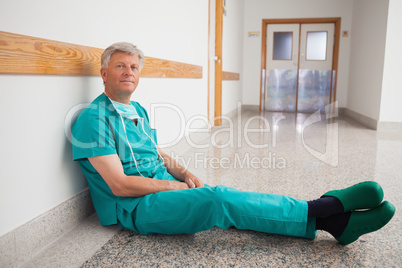 Doctor sitting on the floor smiling