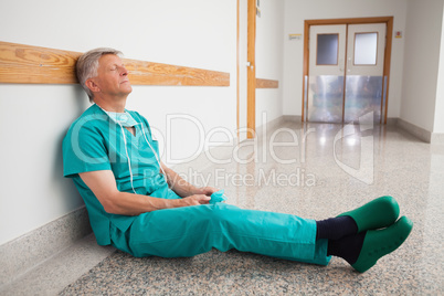 Doctor is sitting on the floor eyes closed
