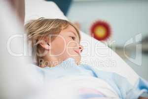 Child lying in hospital bed