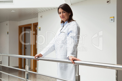 Doctor standing at the railing smiling