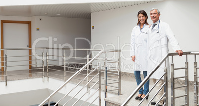 Two doctors standing at top of stairs