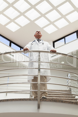 Doctor standing at the railing looking up