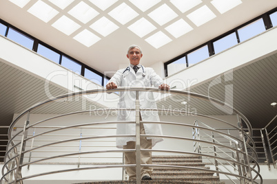 Doctor standing at the railing looking down