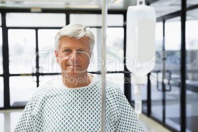 Patient standing in the corridor with IV drip