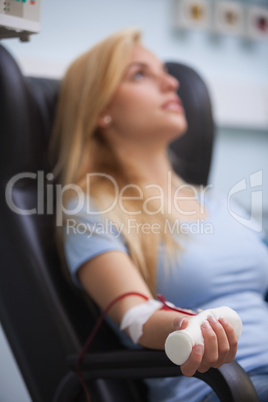 Woman sitting back while getting dialysis