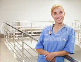 Smiling nurse standing in a stairwell