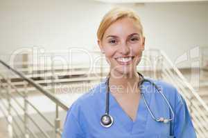 Nurse in a stairwell smiling