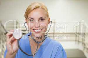 Smiling nurse showing her stethoscope