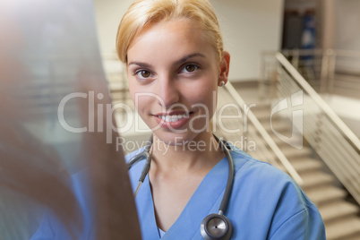 Smiling nurse standing in stairwell