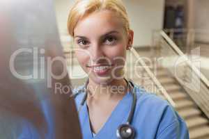 Smiling nurse standing in stairwell
