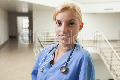 Nurse smiling in stairwell