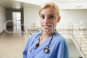 Nurse smiling in stairwell