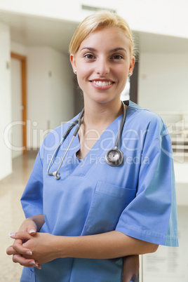 Smiling nurse leaning against stairwell