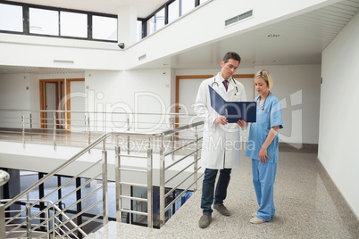 Nurse and doctor looking in folder