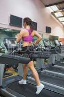 Woman running on a treadmill in a gym