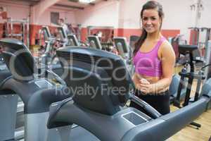 Smiling woman on a treadmill in the gym