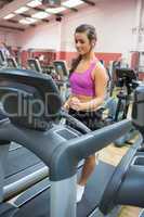 Woman running on a treadmill in a gym concentrating