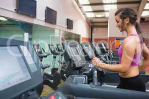 Woman running on a treadmill in a gym