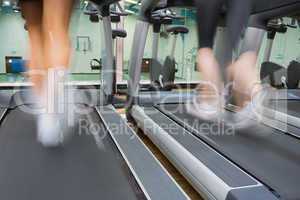 Two people running on treadmills