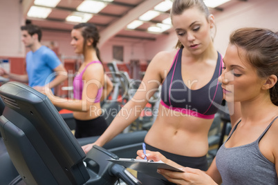 Gym Instructor and woman in the gym