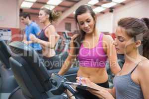 Female gym instructor and woman