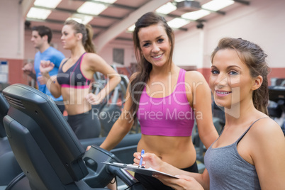 Happy women in the gym during assessment