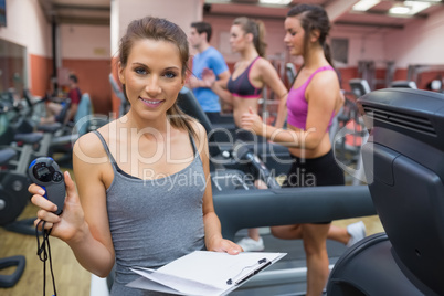 Gym instructor showing stopwatch