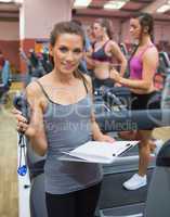 Gym instructor with stopwatch